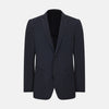 View 1 of product The Charcoal Knitted London Blazer by Turnbull & Asser is a men's single-breasted formal jacket with two buttons, notched lapels, and two front patch pockets, shown against a plain white background.