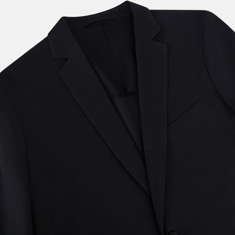 The Charcoal Knitted London Blazer by Turnbull & Asser is a men's single-breasted formal jacket with two buttons, notched lapels, and two front patch pockets, shown against a plain white background.