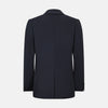 View 3 of product The Charcoal Knitted London Blazer by Turnbull & Asser is a men's single-breasted formal jacket with two buttons, notched lapels, and two front patch pockets, shown against a plain white background.