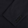 View 4 of product The Charcoal Knitted London Blazer by Turnbull & Asser is a men's single-breasted formal jacket with two buttons, notched lapels, and two front patch pockets, shown against a plain white background.