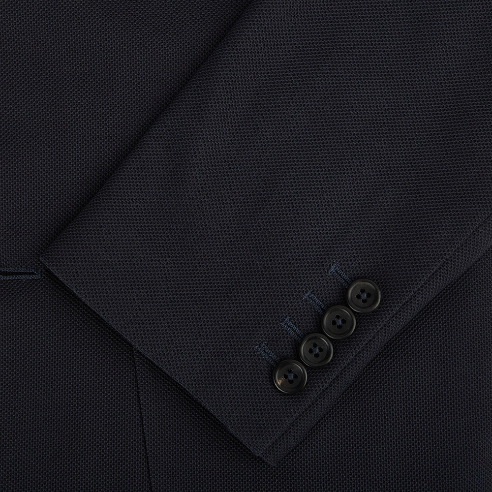 The Charcoal Knitted London Blazer by Turnbull & Asser is a men's single-breasted formal jacket with two buttons, notched lapels, and two front patch pockets, shown against a plain white background.