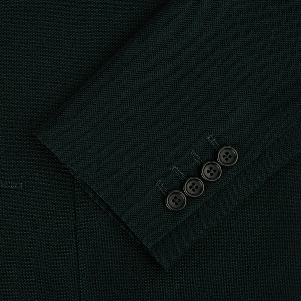 The Turnbull & Asser Forest Green Knitted London Blazer showcases notch lapels, two buttons, patch and chest pockets on a white background—a modern classic for timeless style.