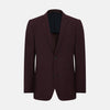 View 1 of product The Turnbull & Asser Burgundy Knitted London Blazer features notch lapels, two front buttons, flap pockets, and a welt chest pocket—ideal for spring and summer—shown against a plain white background.