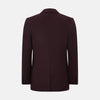 View 3 of product The Turnbull & Asser Burgundy Knitted London Blazer features notch lapels, two front buttons, flap pockets, and a welt chest pocket—ideal for spring and summer—shown against a plain white background.