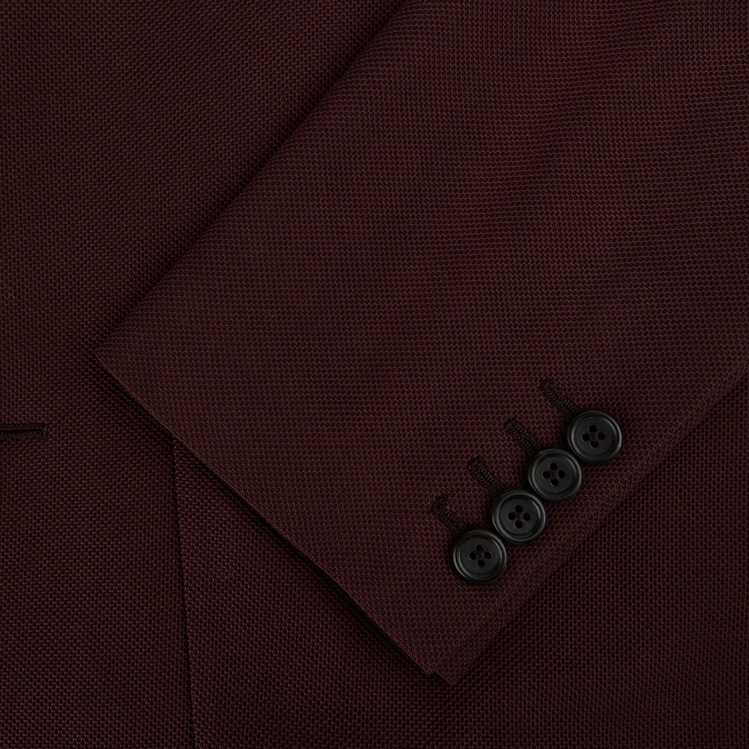 View 4 of product The Turnbull & Asser Burgundy Knitted London Blazer features notch lapels, two front buttons, flap pockets, and a welt chest pocket—ideal for spring and summer—shown against a plain white background.