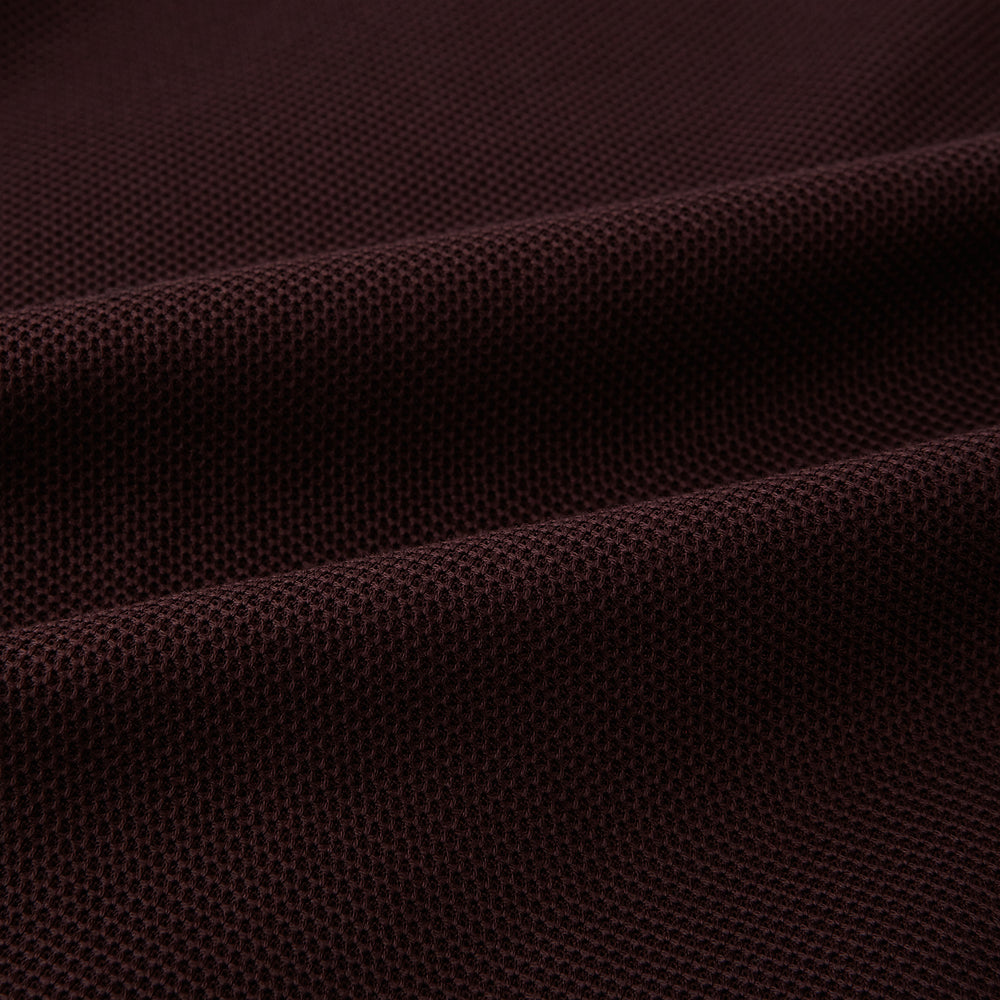 The Turnbull & Asser Burgundy Knitted London Blazer features notch lapels, two front buttons, flap pockets, and a welt chest pocket—ideal for spring and summer—shown against a plain white background.