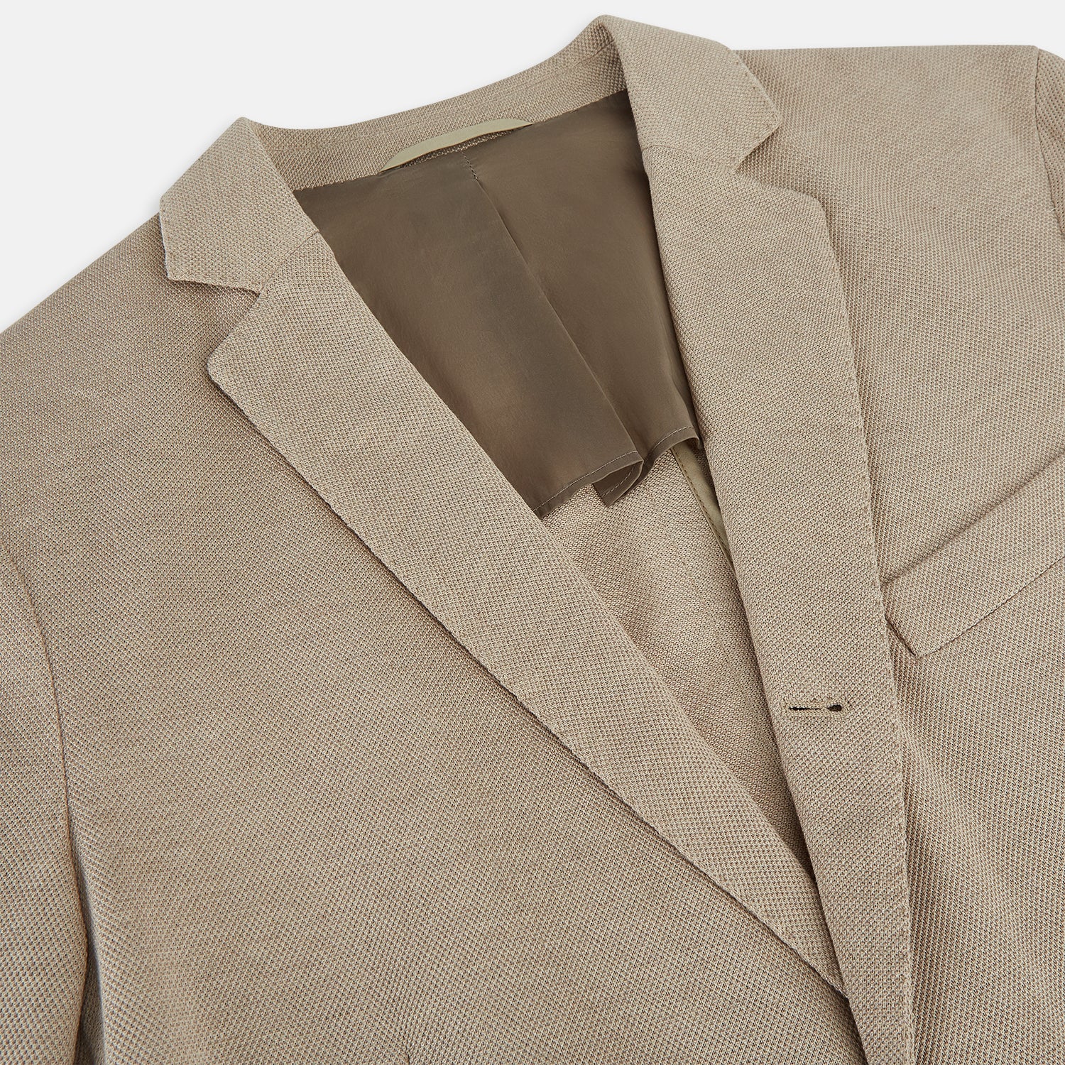 View 2 of product The Turnbull & Asser UK Sand Silk & Cotton Bath Blazer showcases Italian craftsmanship with notched lapels, two front buttons, large patch pockets, and a chest pocket, all set against a plain white background.