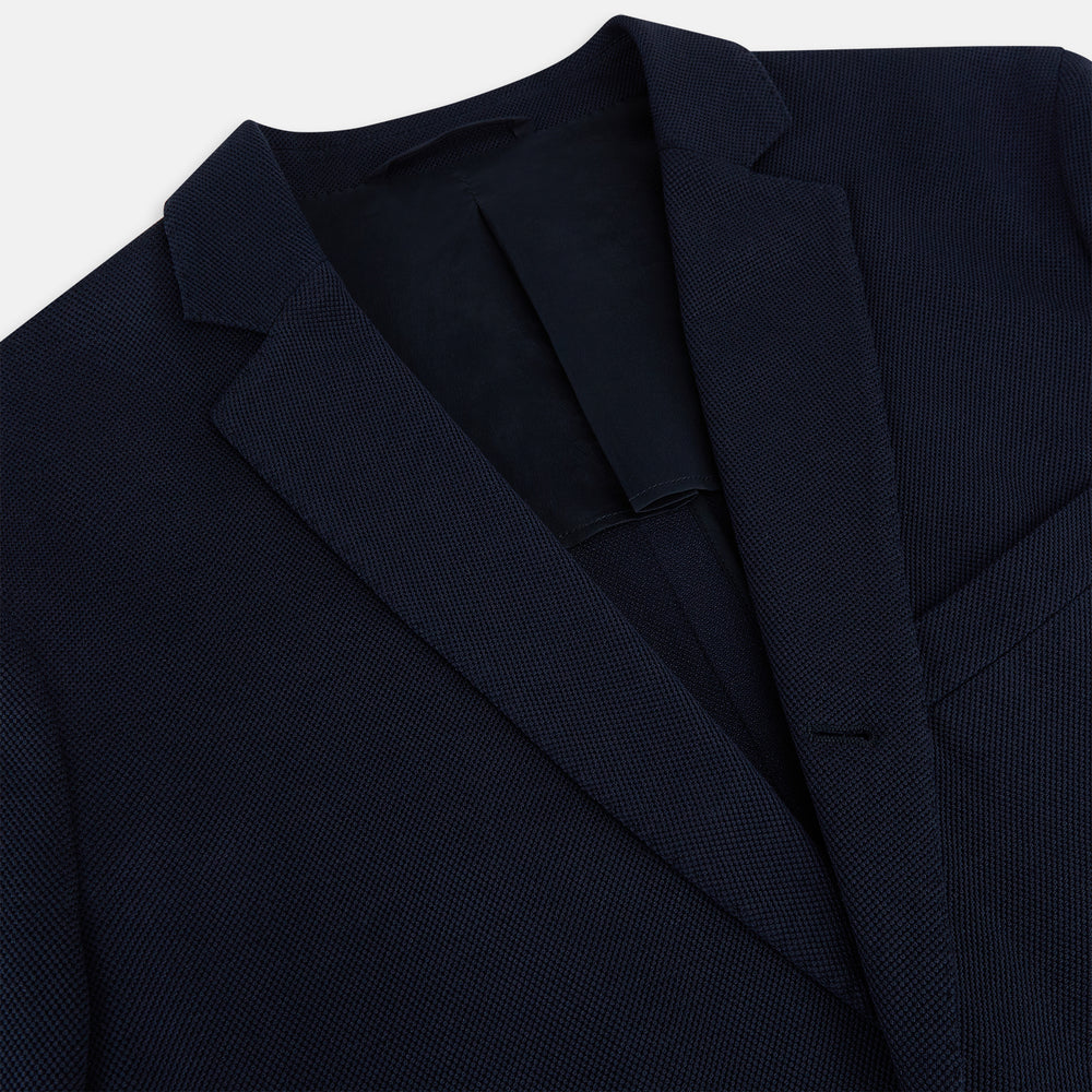 The Turnbull & Asser UK Navy Silk & Cotton Bath Blazer for men features notch lapels, two front pockets, a chest pocket, and a single-breasted button closure, crafted with refined Italian tailoring and shown on a white background.