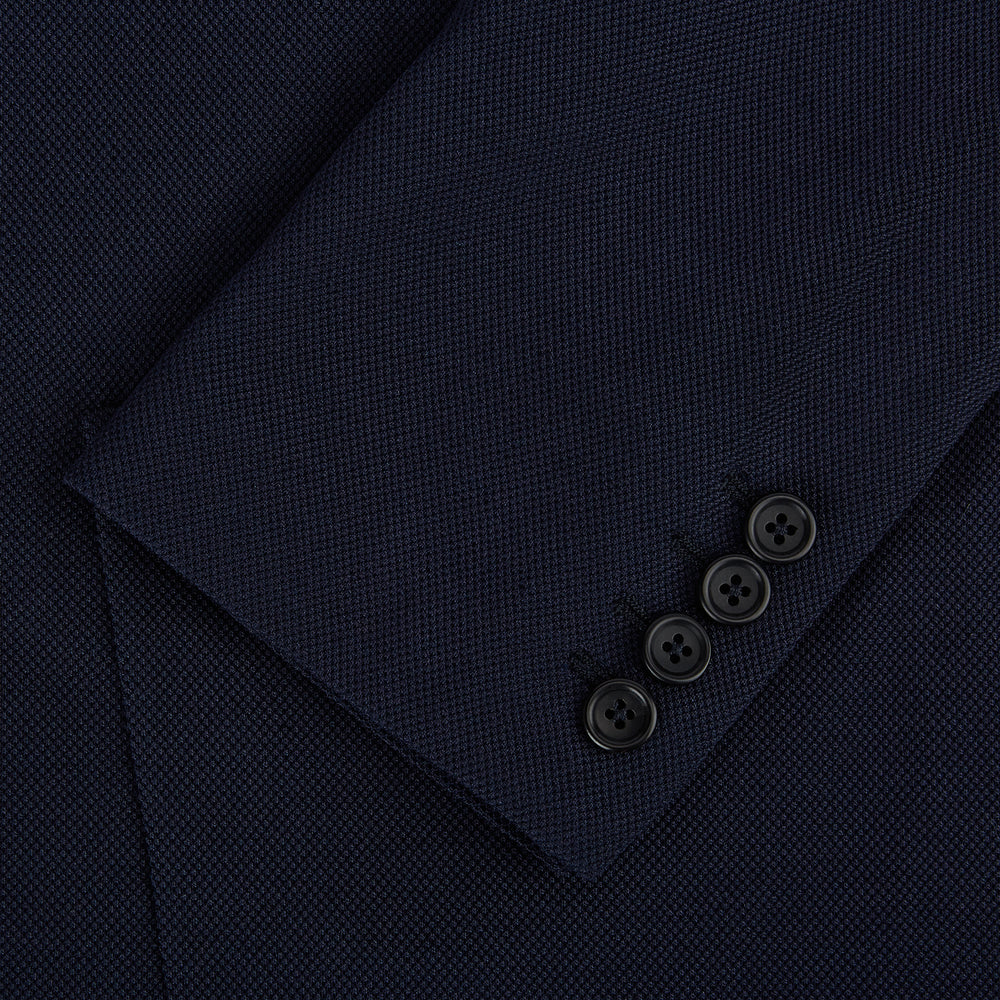 The Turnbull & Asser UK Navy Silk & Cotton Bath Blazer for men features notch lapels, two front pockets, a chest pocket, and a single-breasted button closure, crafted with refined Italian tailoring and shown on a white background.