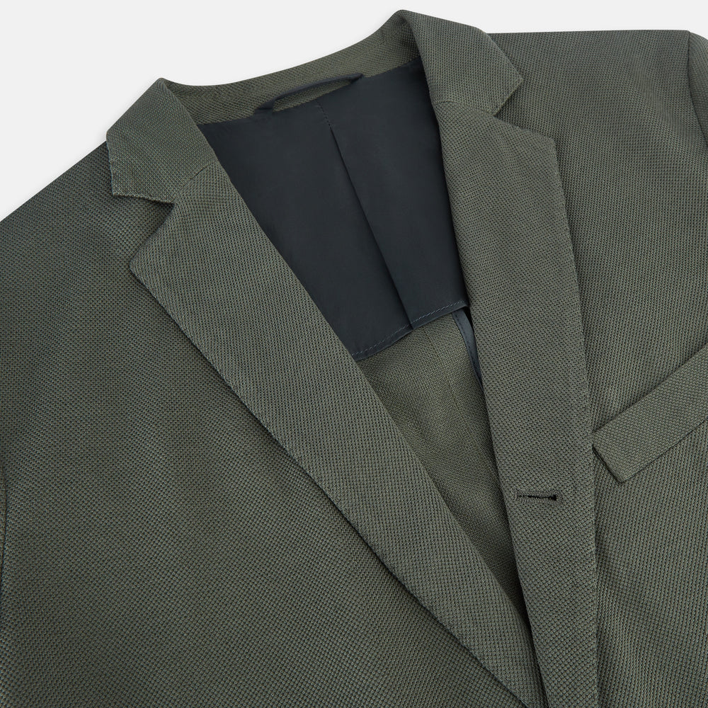 The Turnbull & Asser UK Sage Silk & Cotton Bath Blazer is a single-breasted Italian-tailored piece in olive green, featuring notch lapels, two front patch pockets, a chest pocket, and two buttons, shown on a plain white background.