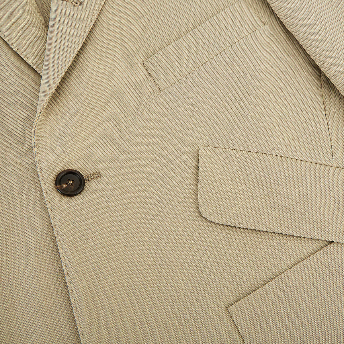 View 8 of product Riviera Sand Oversized Blazer in Cotton by Turnbull & Asser UK, featuring two spacious front pockets, a single chest pocket, and a classic notched lapel. Expertly tailored from premium cotton-nylon stretch fabric, this blazer is shown front-facing against a clean white background—an essential piece for achieving effortless sophistication.