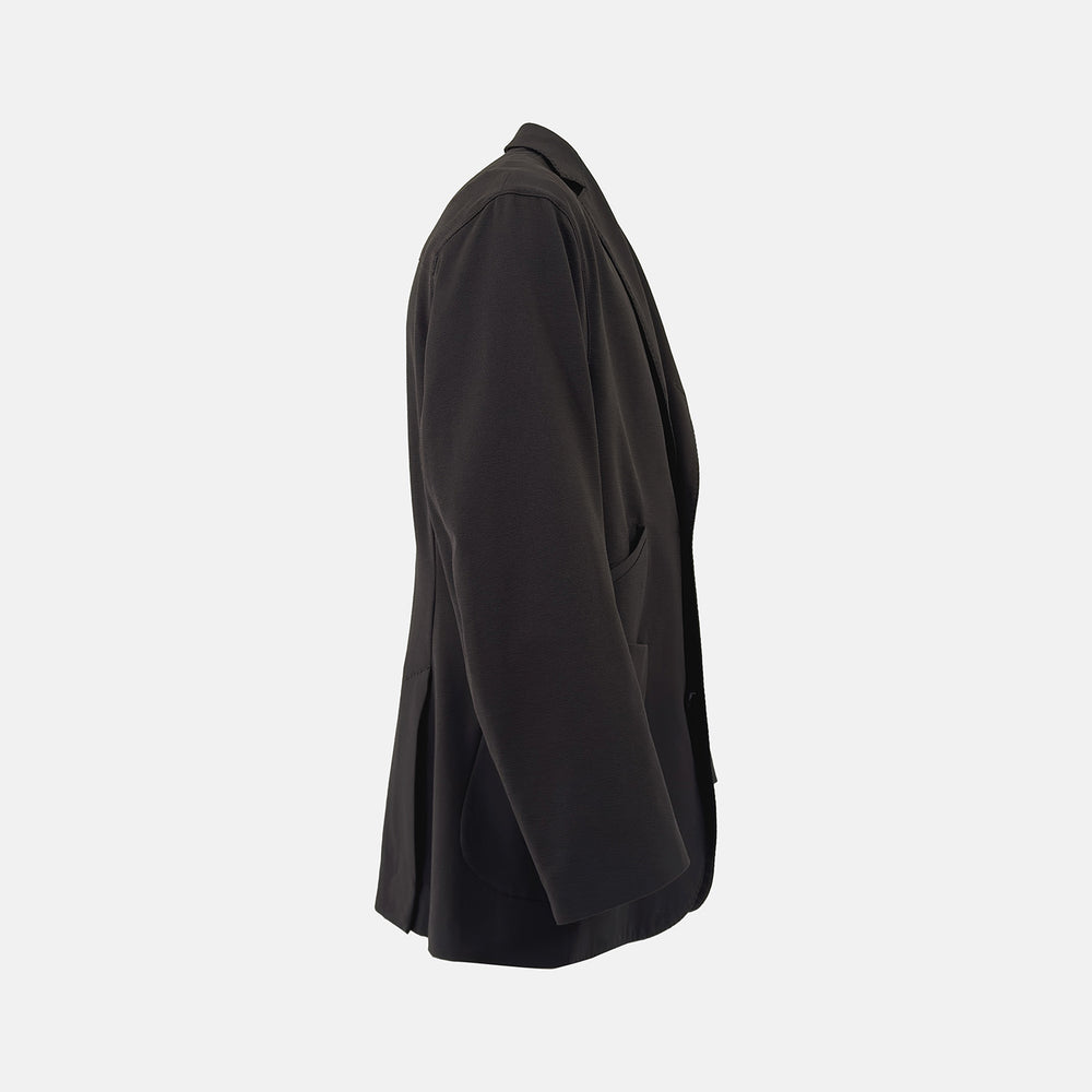 Introducing the Riviera Chocolate Oversized Blazer in Cotton by Turnbull & Asser UK—a dark brown blazer featuring two front buttons, three patch pockets, and notch lapels. Crafted from a cotton-nylon stretch fabric and showcased against a plain white background, this piece is a timeless addition to your autumn wardrobe.