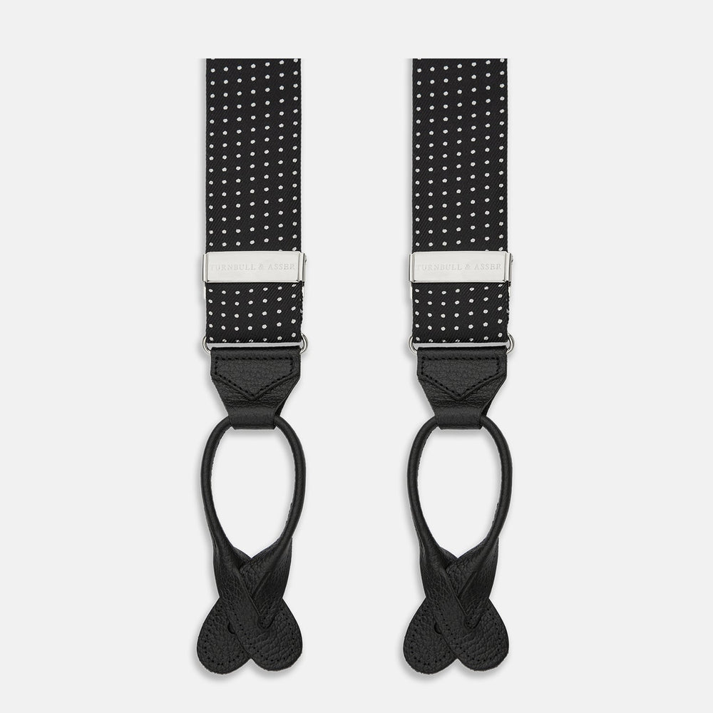 Turnbull & Asser Black & White Small Spot Adjustable Silk Braces with leather loops and silver adjusters, featuring small white polka dots—perfect for refined style and shown against a white background.