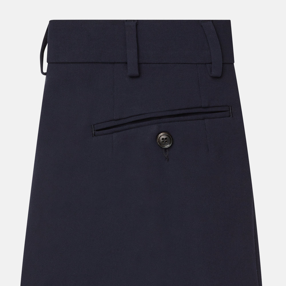 The Navy Blue James Trouser by Turnbull & Asser features a tailored straight-leg cut, flat front, belt loops, and button closure, shown on a plain white background for an elegant and versatile look.