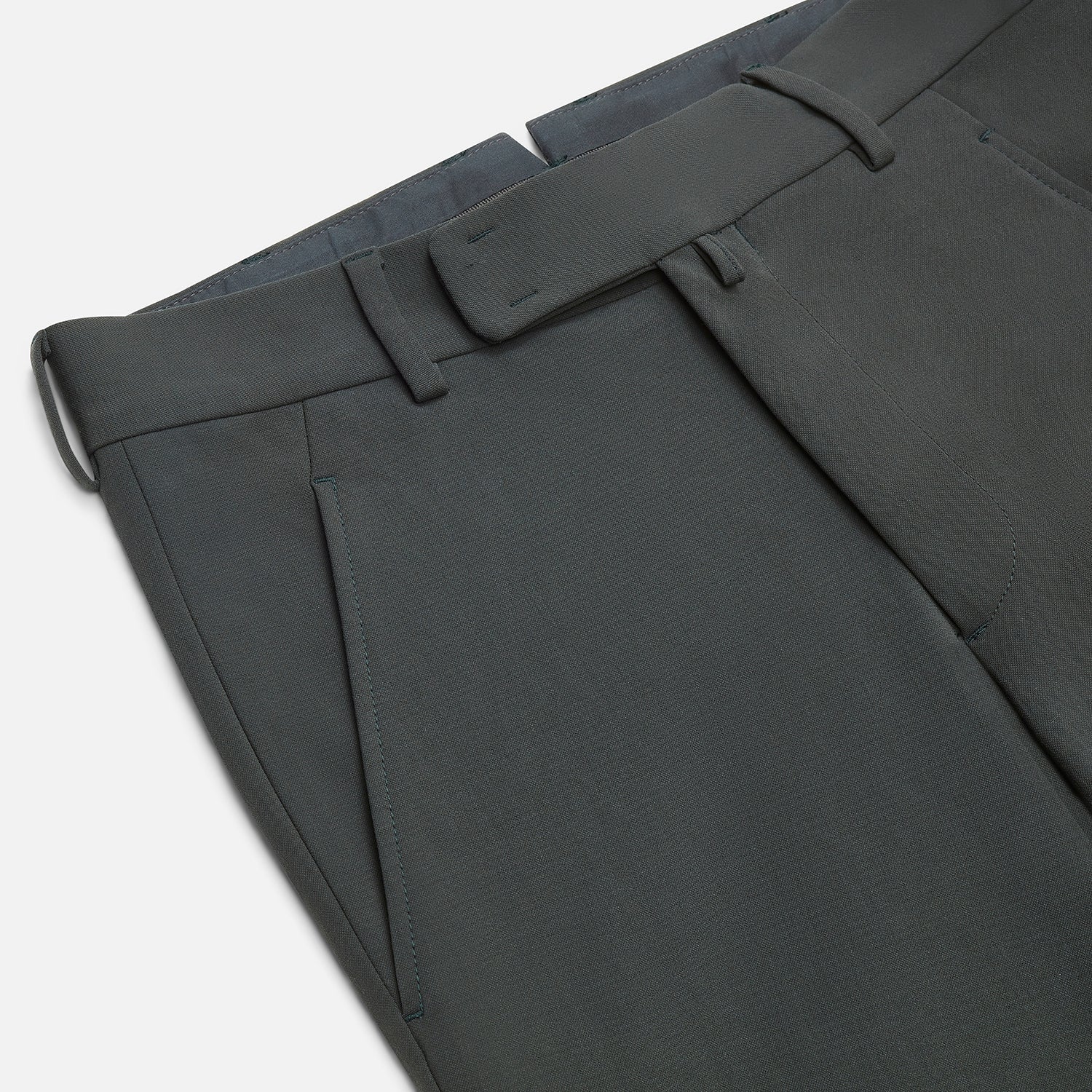 View 2 of product A pair of slim-fit Dark Green James trousers by Turnbull & Asser in Italian cotton, featuring belt loops, side pockets, and a flat front, shown against a plain white background.