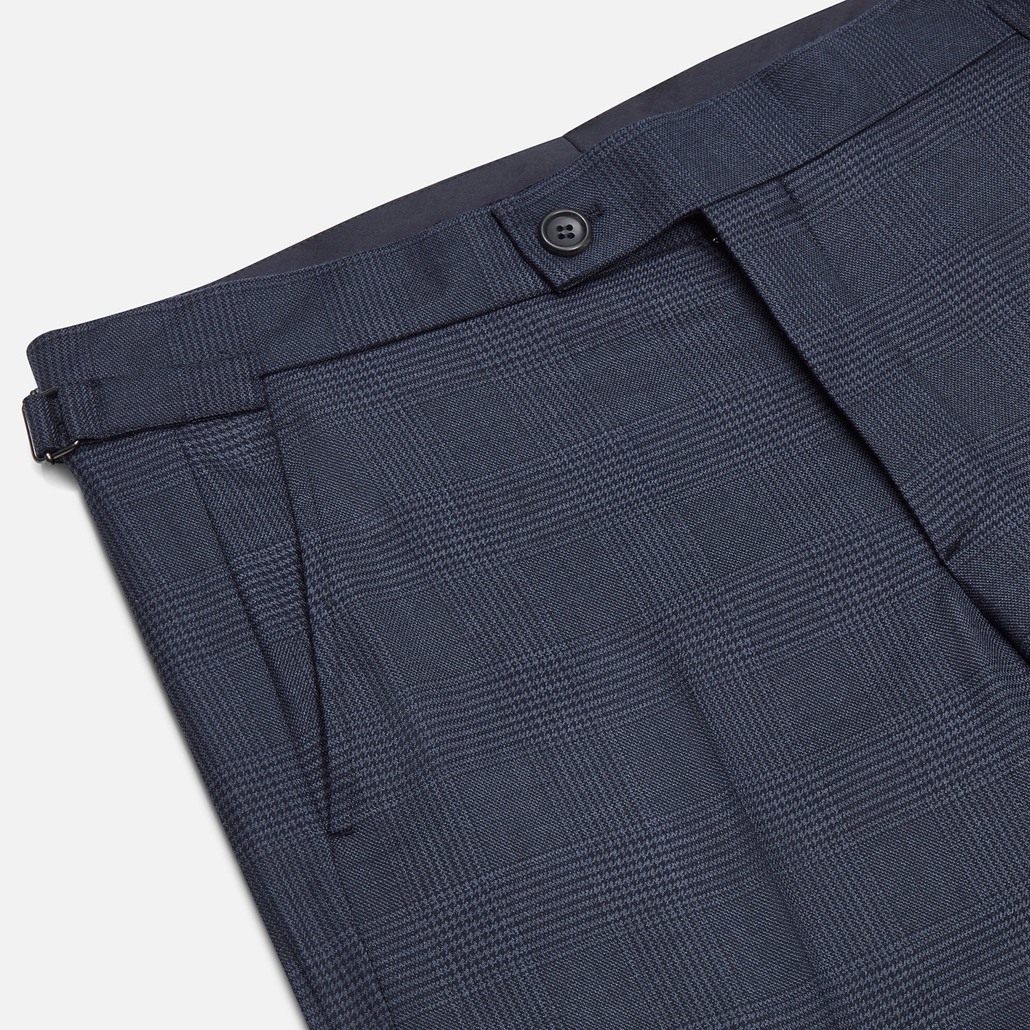 View 2 of product The Navy Check Henry Trousers by Turnbull & Asser are tailored-fit, dark blue pants with a subtle check pattern, front pockets, button closure, and belt loops, crafted from premium Italian wool and displayed on a plain white background.