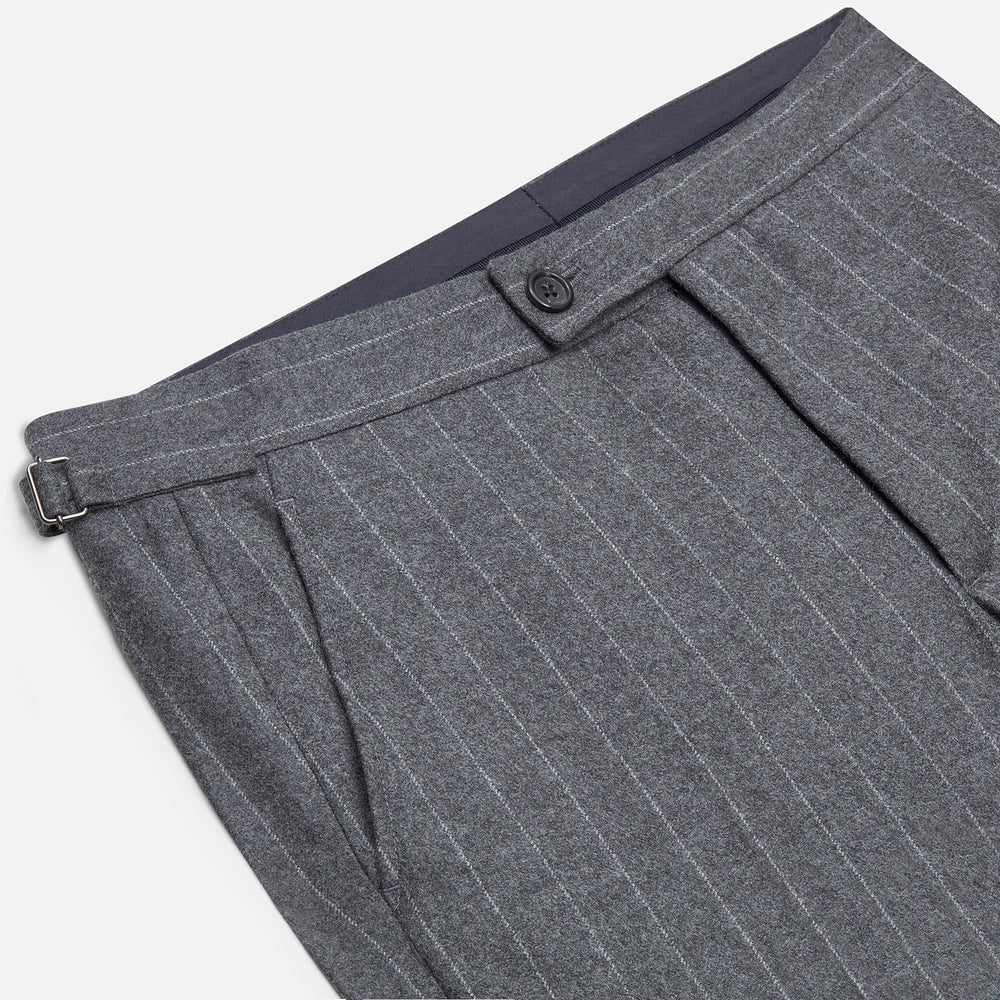 The Turnbull & Asser Grey Pinstripe Henry Trousers feature a tailored fit, white vertical stripes, button closure, and belt loops, displayed on a plain white background.