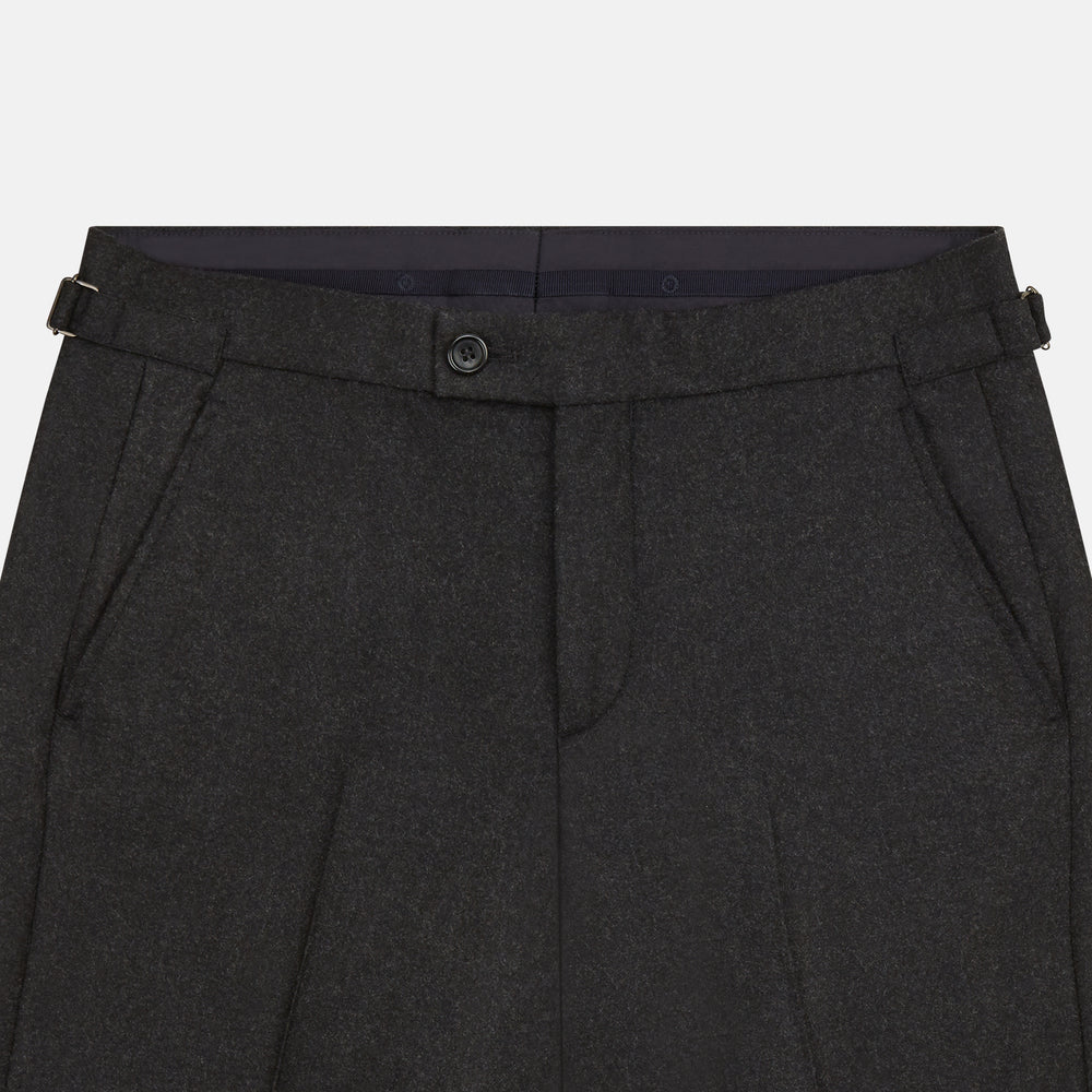 Turnbull & Asser’s Charcoal Henry Trousers, crafted from a wool-cashmere blend with button and zip closure, belt loops, and side pockets, are shown laid flat on a white background.