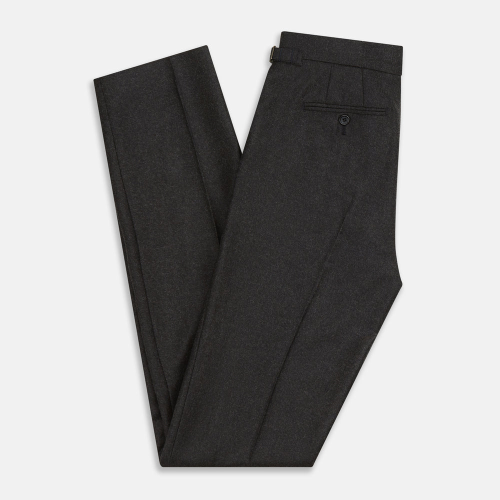 Turnbull & Asser’s Charcoal Henry Trousers, crafted from a wool-cashmere blend with button and zip closure, belt loops, and side pockets, are shown laid flat on a white background.