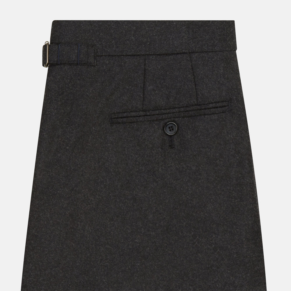 Turnbull & Asser’s Charcoal Henry Trousers, crafted from a wool-cashmere blend with button and zip closure, belt loops, and side pockets, are shown laid flat on a white background.