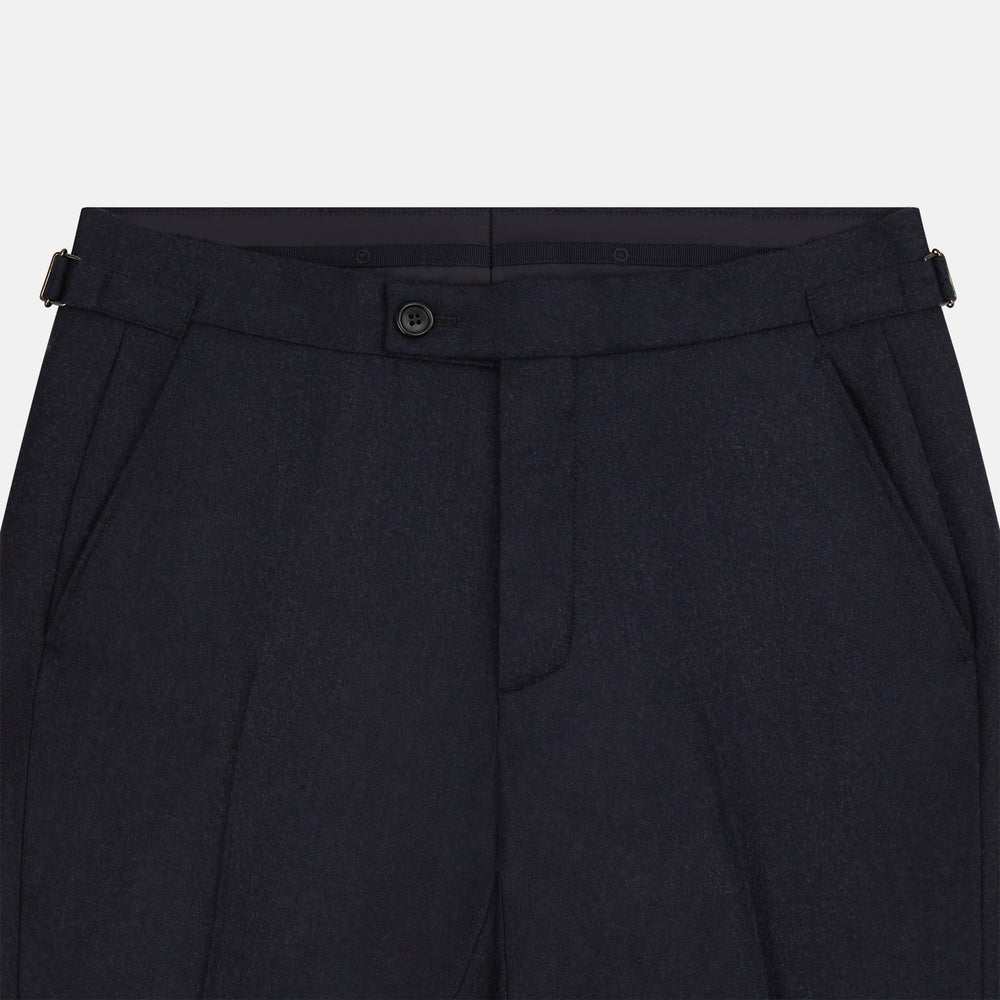 The Turnbull & Asser Navy Henry Trousers are tailored from a luxurious wool-cashmere blend, featuring front pleats, straight legs, and a button closure. Shown here laid flat on a white background.