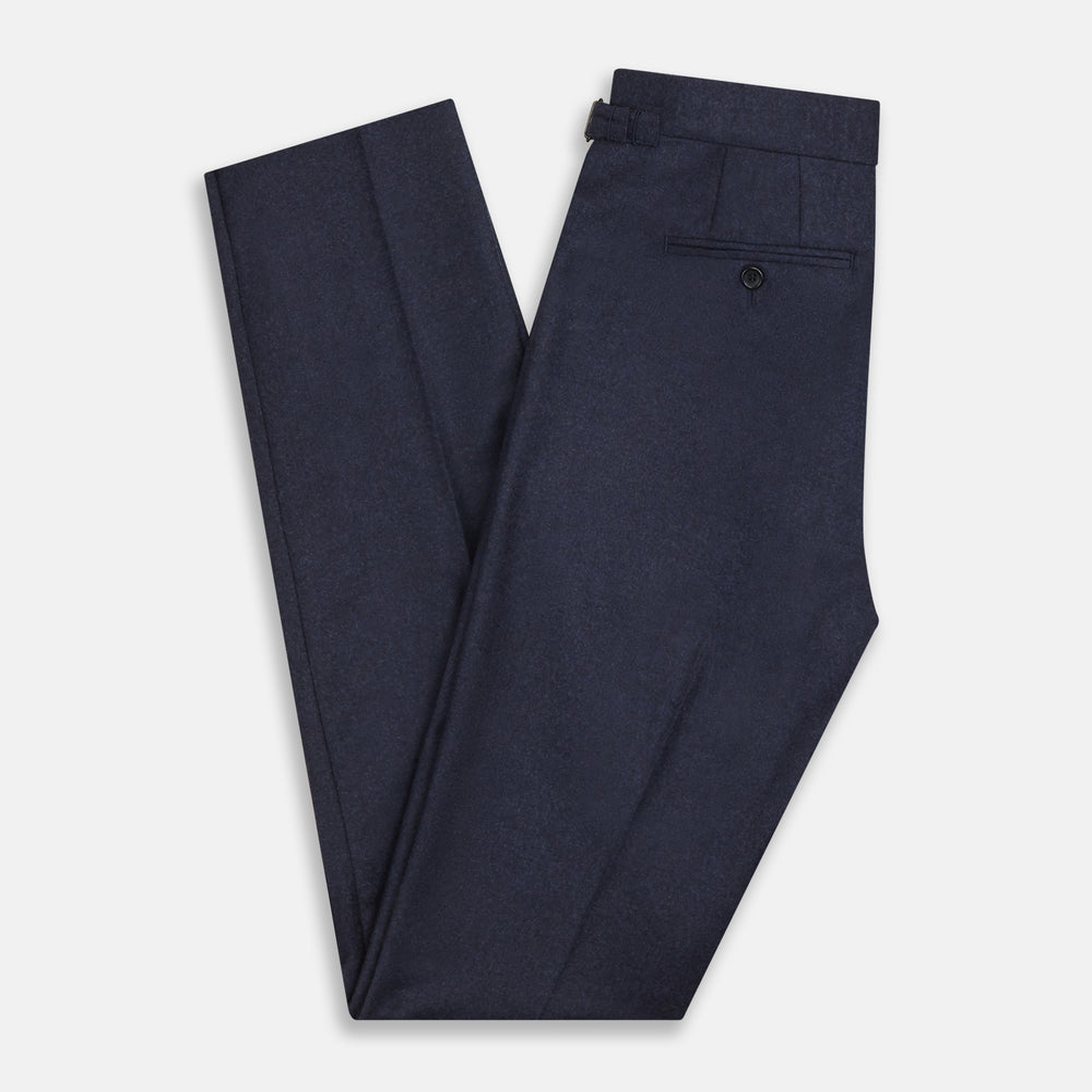 Turnbull & Asser’s Dark Blue Henry Trousers in a wool-cashmere blend feature a button closure, front pleats, and side pockets, shown laid flat on a white background.