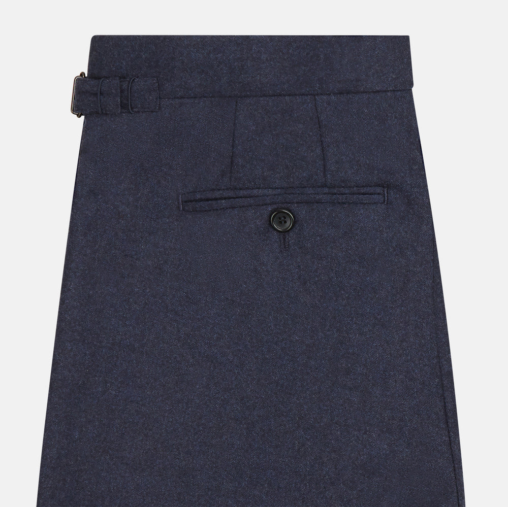 Turnbull & Asser’s Dark Blue Henry Trousers in a wool-cashmere blend feature a button closure, front pleats, and side pockets, shown laid flat on a white background.