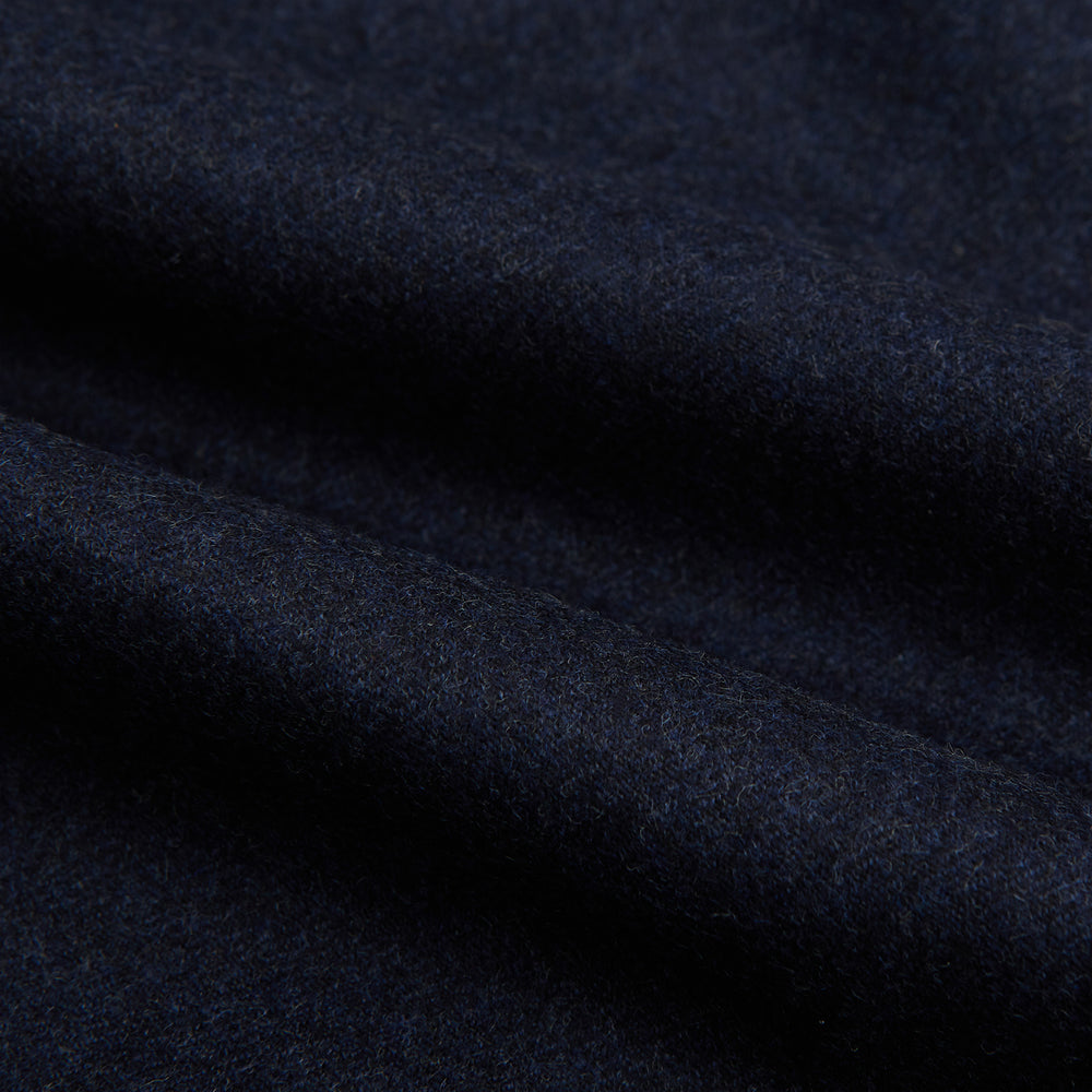 Turnbull & Asser’s Dark Blue Henry Trousers in a wool-cashmere blend feature a button closure, front pleats, and side pockets, shown laid flat on a white background.