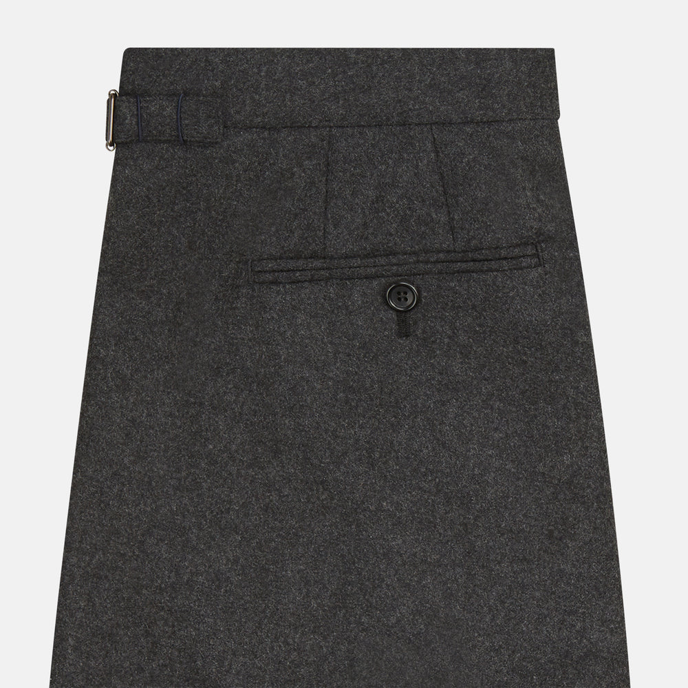 Turnbull & Asser's Dark Grey Henry Trousers are tailored, straight-leg trousers in a luxurious wool-cashmere blend with button and zip closure, belt loops, and front pleats, shown against a white background.