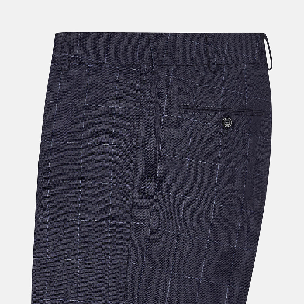 Turnbull & Asser Navy Check Edward Trousers feature a subtle white windowpane pattern, pleated front, belt loops, and button closure, shown against a plain white background.