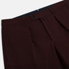 View 2 of product A pair of Burgundy Knitted London Trousers by Turnbull & Asser, featuring a tailored fit, button closure, front pleats, belt loops, and straight legs, displayed on a plain white background.