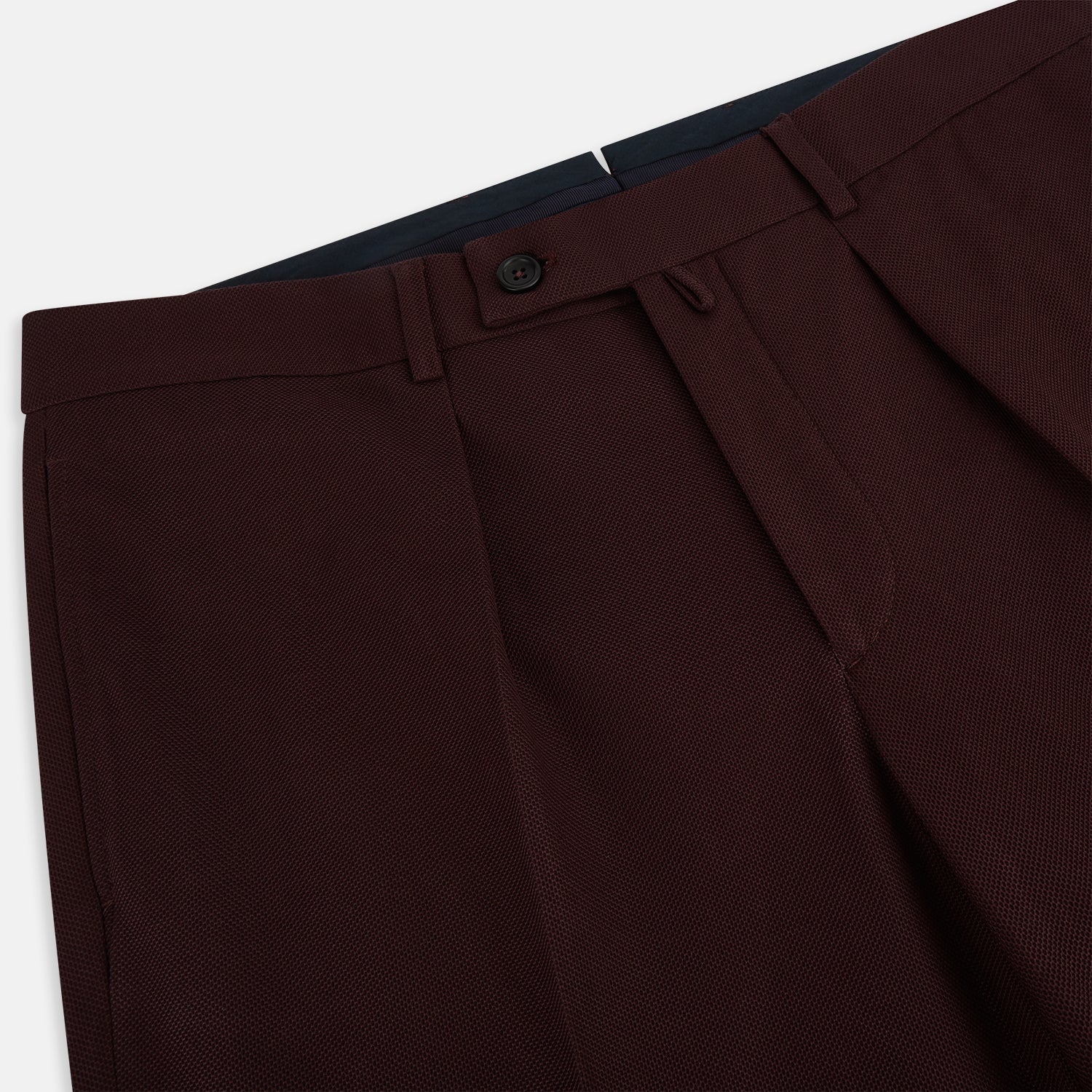 View 2 of product A pair of Burgundy Knitted London Trousers by Turnbull & Asser, featuring a tailored fit, button closure, front pleats, belt loops, and straight legs, displayed on a plain white background.