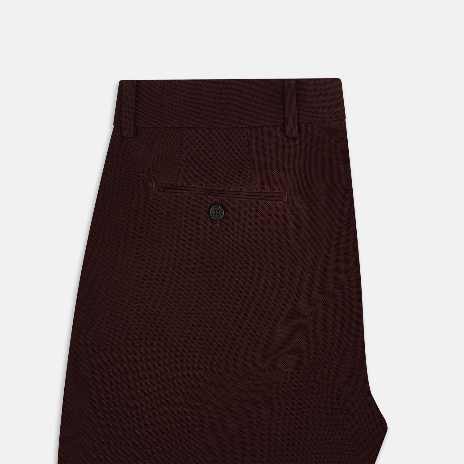 View 5 of product A pair of Burgundy Knitted London Trousers by Turnbull & Asser, featuring a tailored fit, button closure, front pleats, belt loops, and straight legs, displayed on a plain white background.