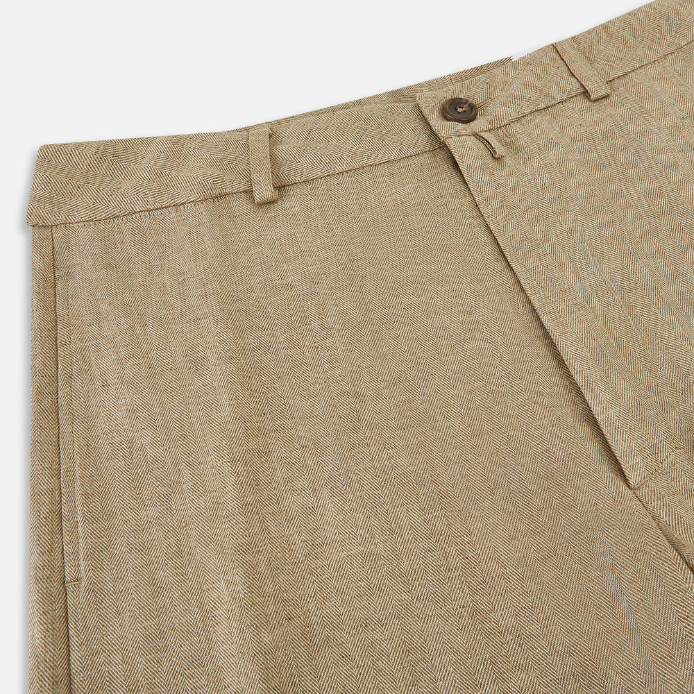 The Sand Linen Amberley Trousers by Turnbull & Asser UK are high-waisted, straight-leg, light brown herringbone linen trousers with belt loops, a front button, and zip closure, shown against a plain white background.