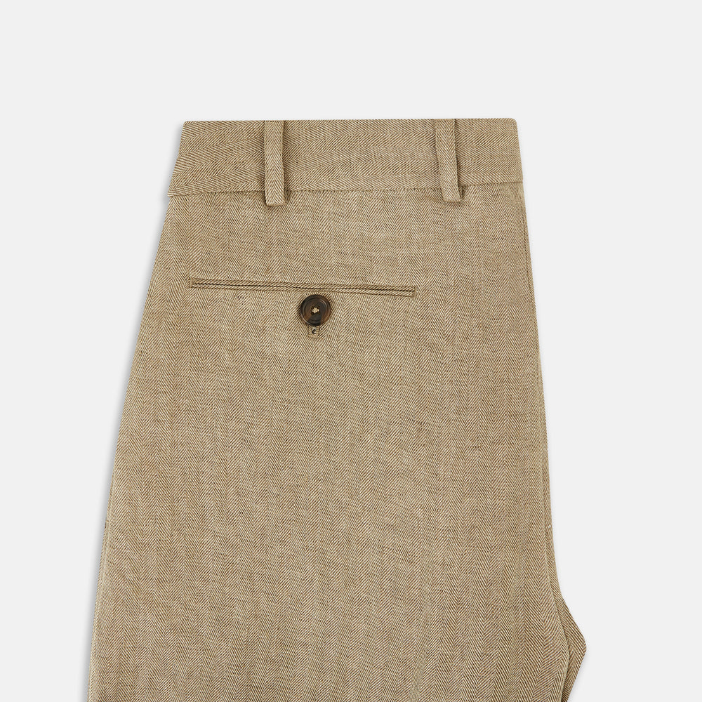 The Sand Linen Amberley Trousers by Turnbull & Asser UK are high-waisted, straight-leg, light brown herringbone linen trousers with belt loops, a front button, and zip closure, shown against a plain white background.