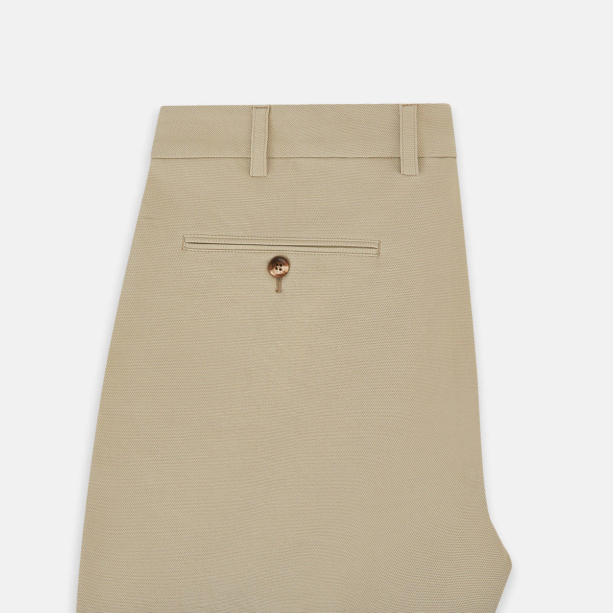 View 4 of product Amberley Sand Trousers in Cotton by Turnbull & Asser UK, featuring a straight-leg silhouette in beige cotton canvas with a button and zip closure, displayed against a plain white background.