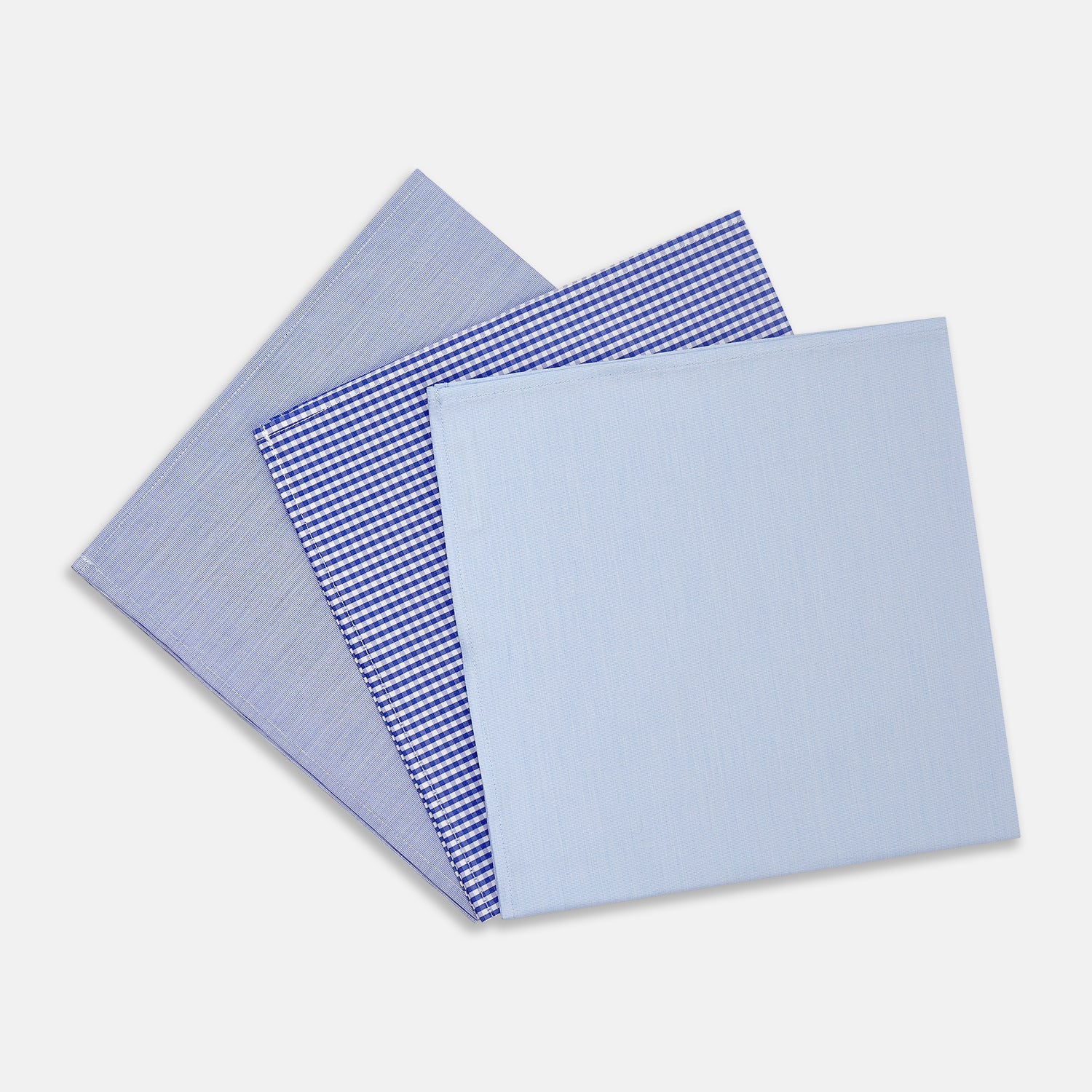 View 1 of product Turnbull & Asser's Blue Cotton Handkerchiefs 3-pack features three luxury designs—light blue, blue and white checks, and subtle stripes—elegantly displayed on a plain white background.
