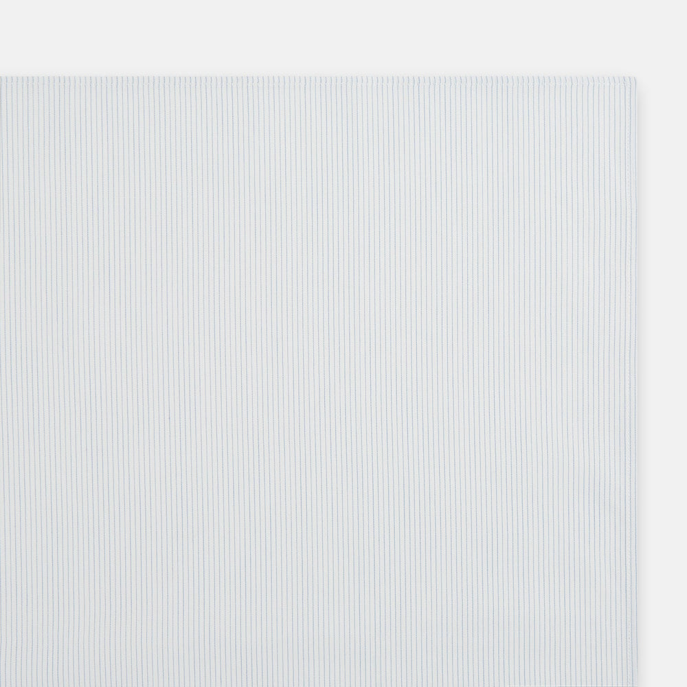 The Turnbull & Asser Blue Pencil Stripe Handkerchief is shown folded on a white background, highlighting its refined design as a perfect formal accessory.