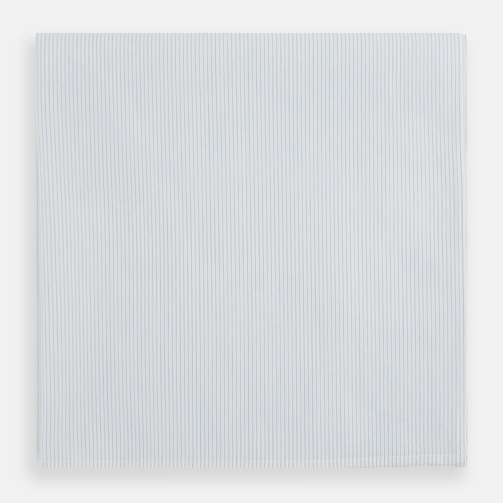 The Turnbull & Asser Blue Pencil Stripe Handkerchief is shown folded on a white background, highlighting its refined design as a perfect formal accessory.