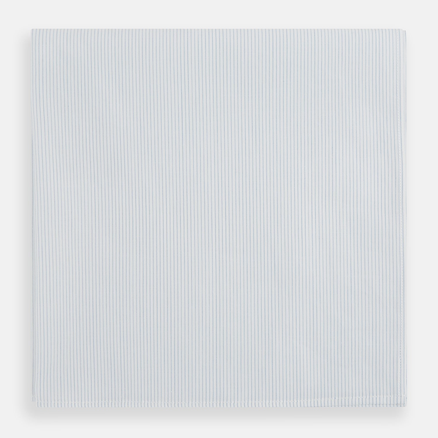 View 1 of product The Turnbull & Asser Blue Pencil Stripe Handkerchief is shown folded on a white background, highlighting its refined design as a perfect formal accessory.