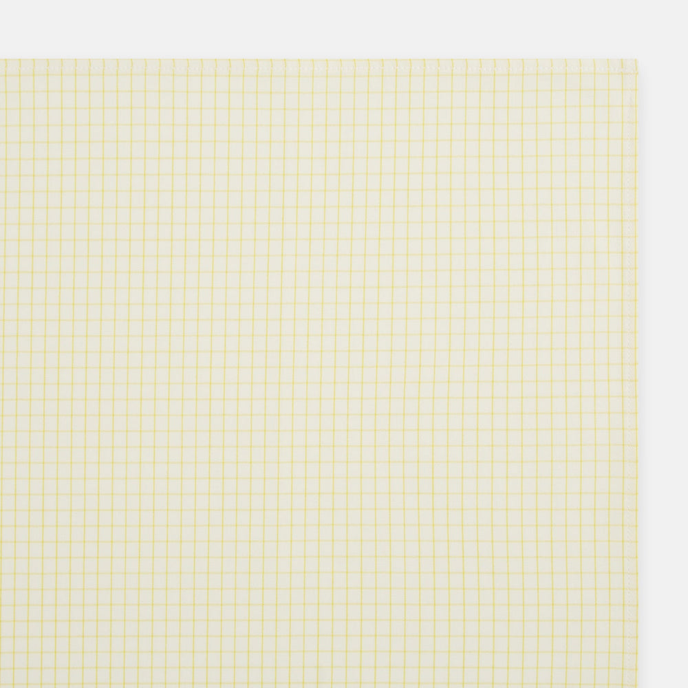 The Yellow Graph Check Handkerchief by Turnbull & Asser features a light yellow background with evenly spaced, thin yellow grid lines forming small squares—evoking the look of classic graph paper.
