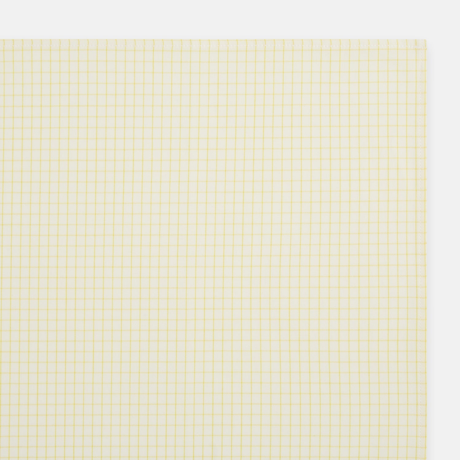 View 2 of product The Yellow Graph Check Handkerchief by Turnbull & Asser features a light yellow background with evenly spaced, thin yellow grid lines forming small squares—evoking the look of classic graph paper.