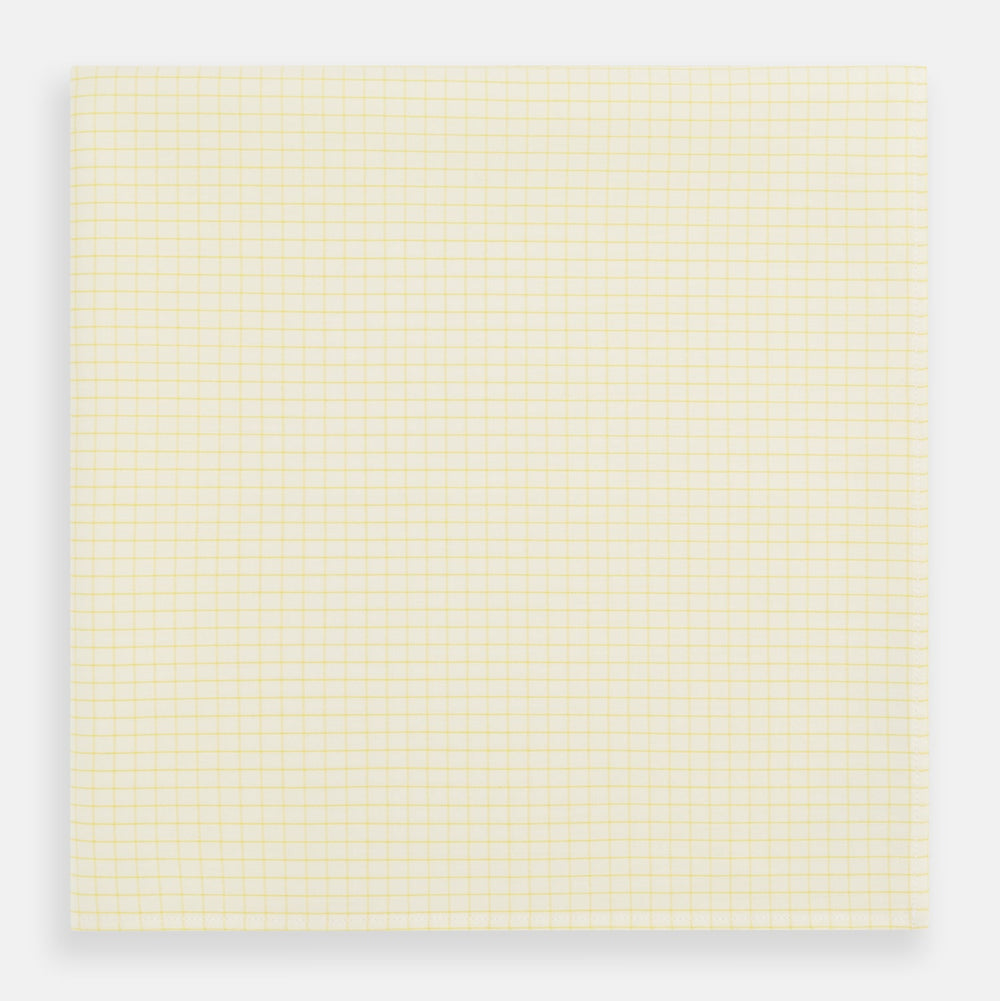 The Yellow Graph Check Handkerchief by Turnbull & Asser features a light yellow background with evenly spaced, thin yellow grid lines forming small squares—evoking the look of classic graph paper.