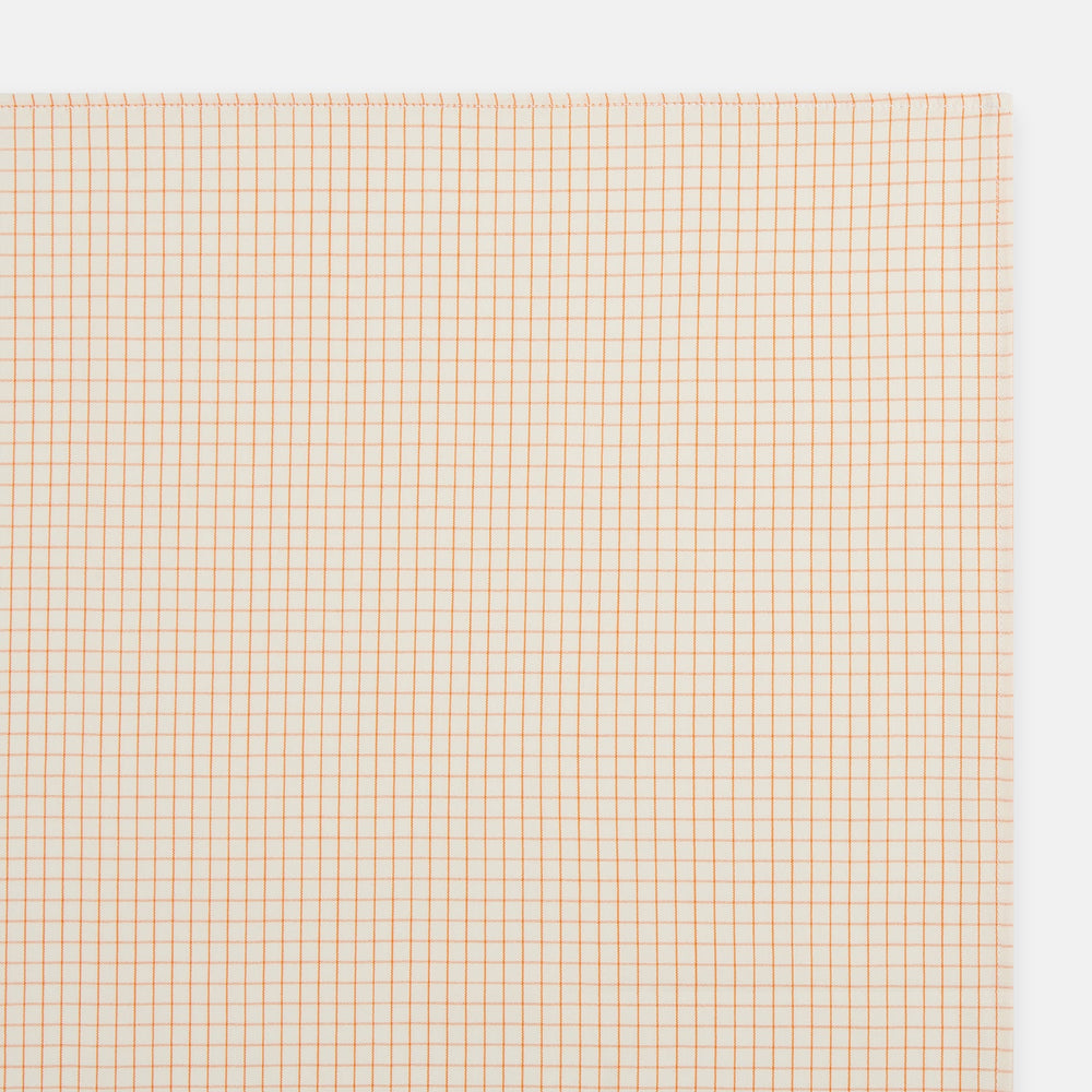 The Turnbull & Asser Orange Graph Check Handkerchief features a square cotton design with an orange and white graph check pattern, making it a stylish formal accessory.