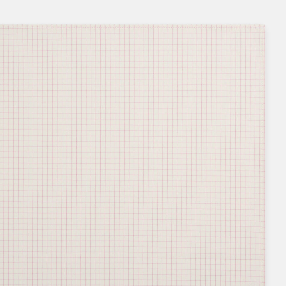 The Turnbull & Asser Pink Graph Check Handkerchief features a subtle red checkered grid on pink cotton, making it a refined formal accessory, as elegantly shown against a white background.