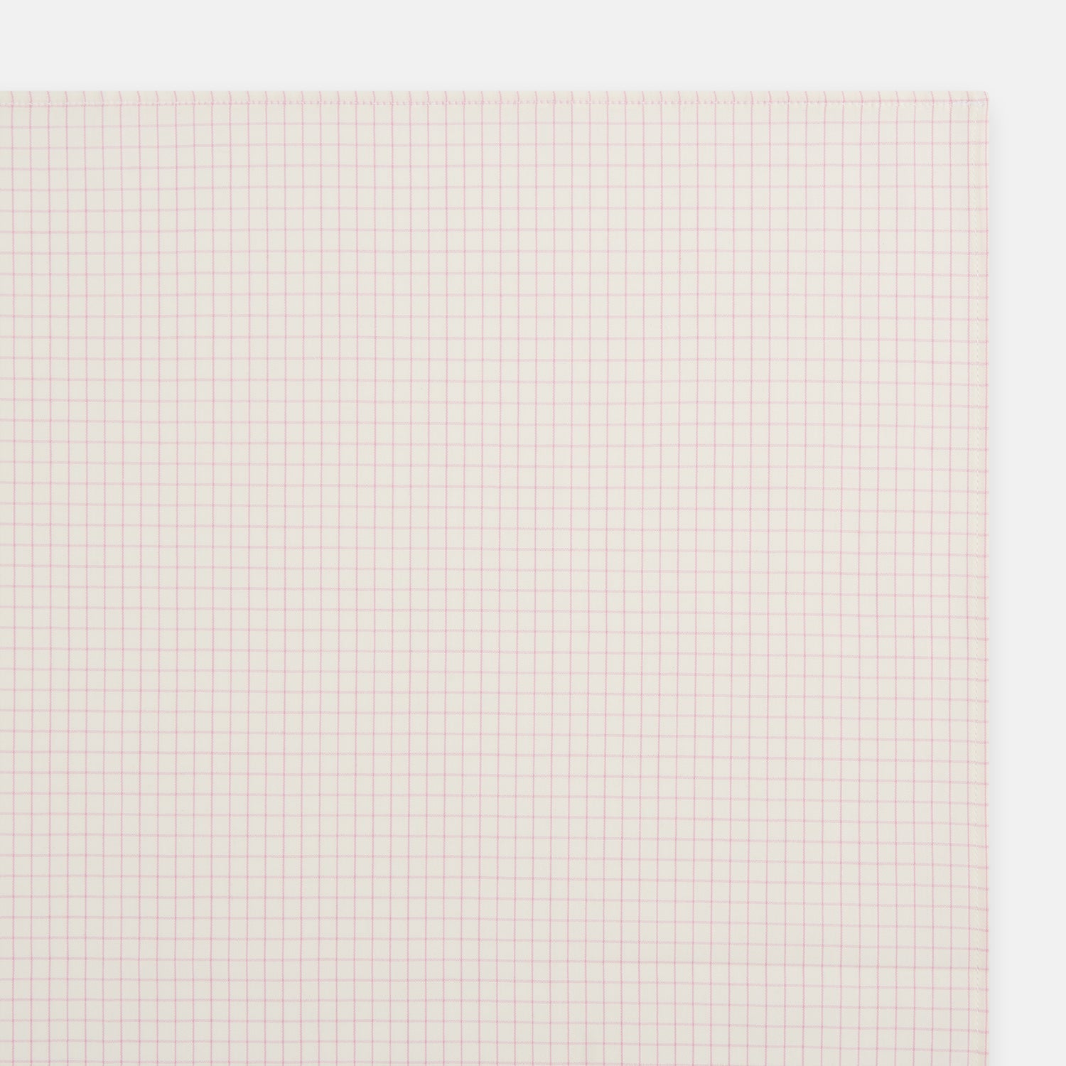 View 2 of product The Turnbull & Asser Pink Graph Check Handkerchief features a subtle red checkered grid on pink cotton, making it a refined formal accessory, as elegantly shown against a white background.