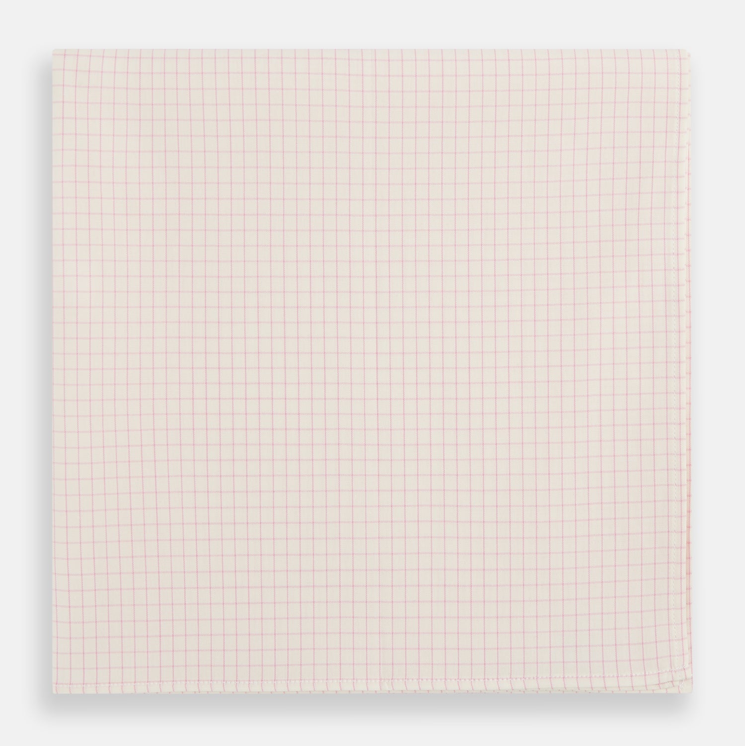 View 1 of product The Turnbull & Asser Pink Graph Check Handkerchief features a subtle red checkered grid on pink cotton, making it a refined formal accessory, as elegantly shown against a white background.