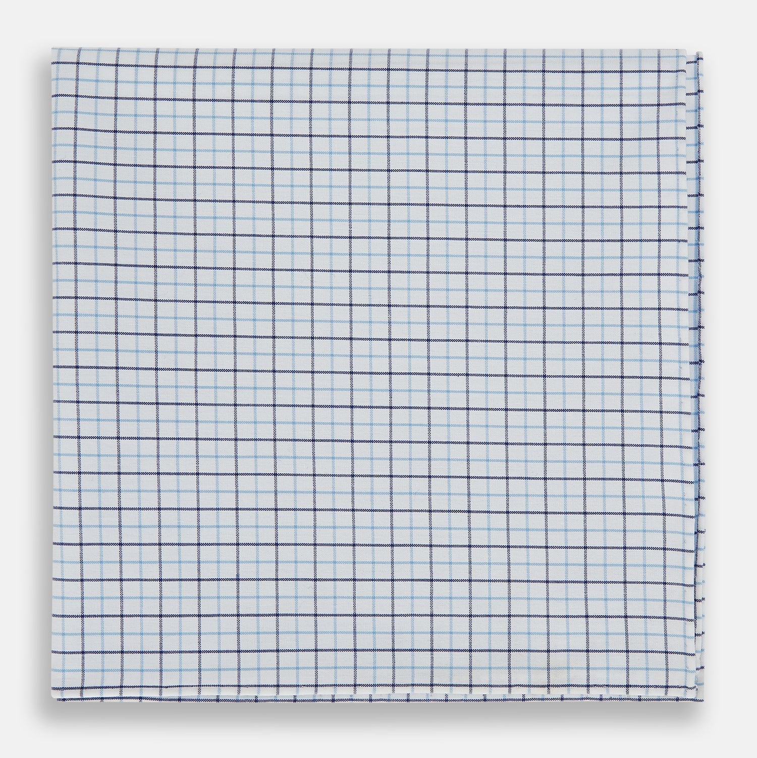 View 1 of product The Turnbull & Asser Hand Rolled Blue Double Graph Check Handkerchief features a cotton square with a blue and navy grid pattern, refined hand-rolled edges, and serves as an elegant gentleman's accessory.