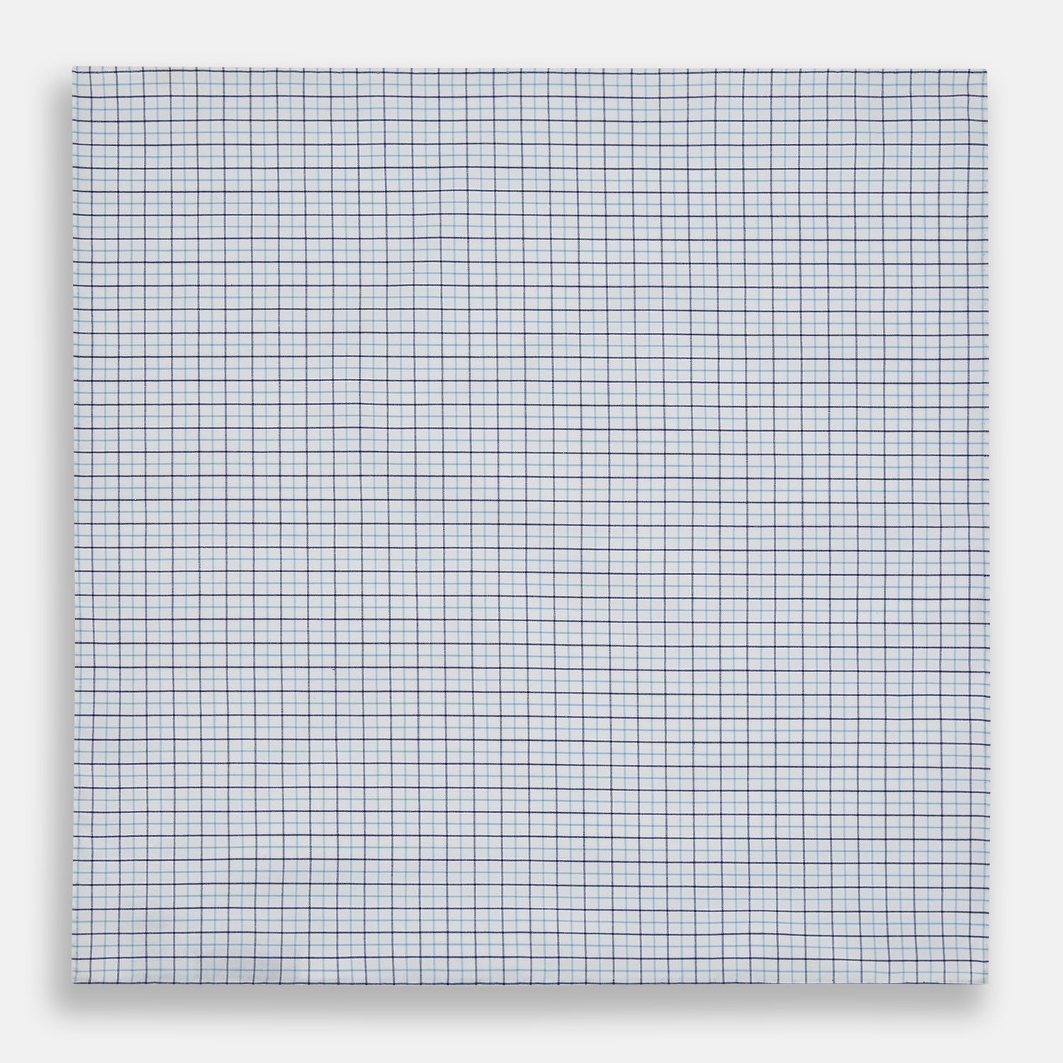 View 3 of product The Turnbull & Asser Hand Rolled Blue Double Graph Check Handkerchief features a cotton square with a blue and navy grid pattern, refined hand-rolled edges, and serves as an elegant gentleman's accessory.