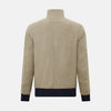 View 3 of product A Fairway Sand Golf Jacket in Linen by Turnbull & Asser UK, crafted from lightweight herringbone linen, features a front zipper, a chest zip pocket, two side zip pockets, and dark navy cuffs, collar lining, and waistband. Shown on a plain white background.